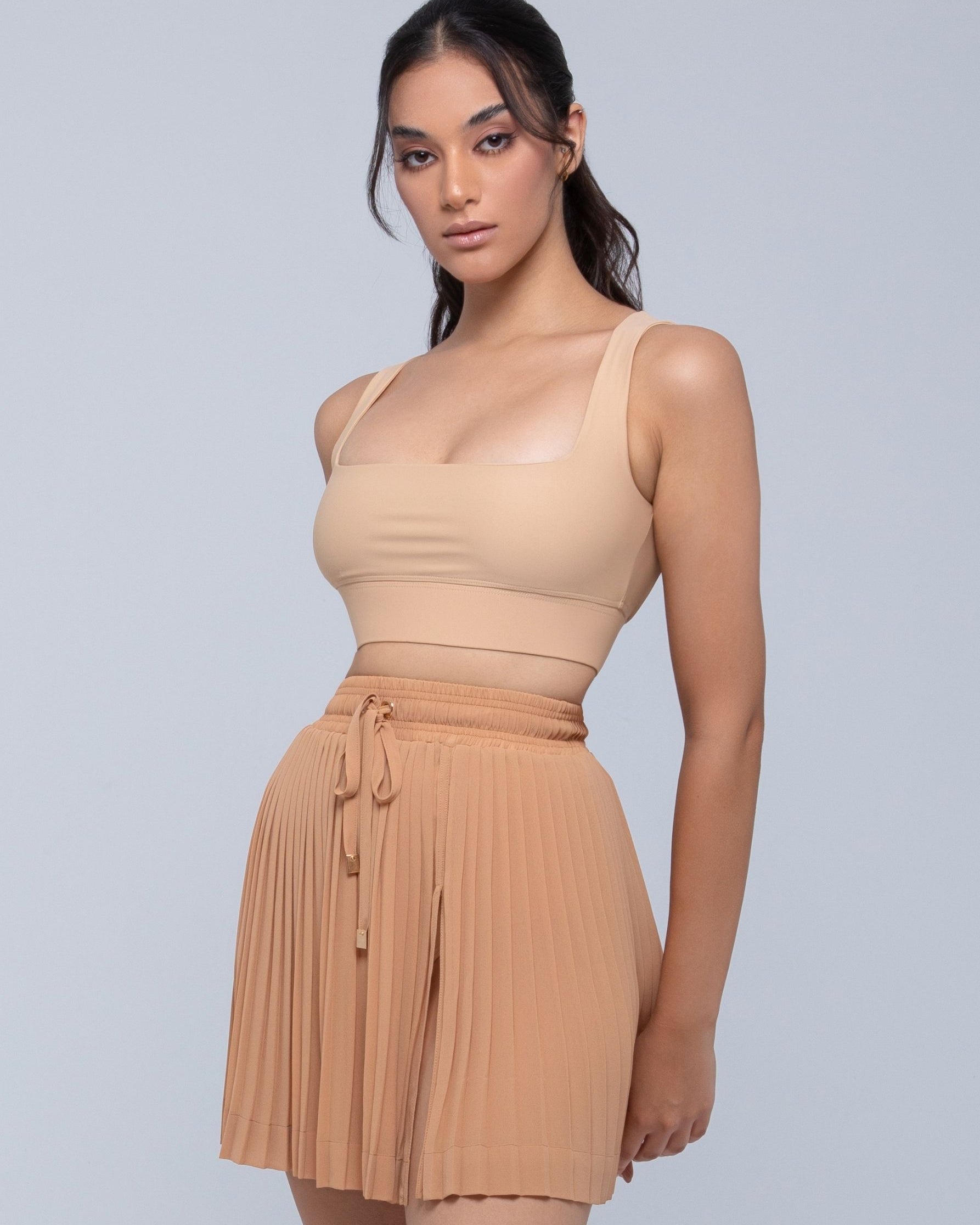 Sheer mini skirt with pleated lightweight fabric and one-side slit