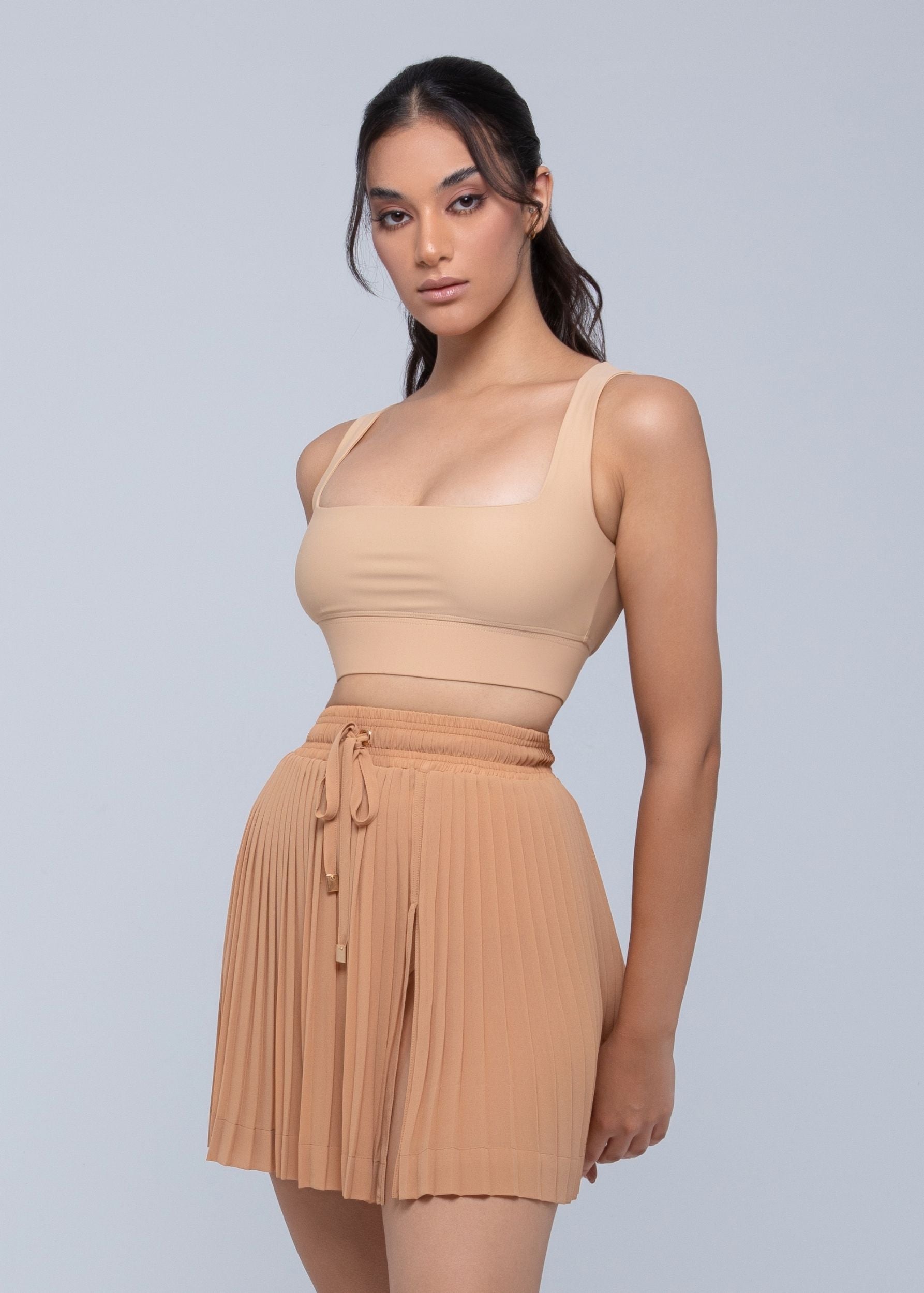Sheer mini skirt with pleated lightweight fabric and one-side slit