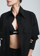 This image features a stylishly Fierce oversized black shirt, modeled in a way that emphasizes its loose fit and sophisticated design. The shirt is button-up and has a classic collar, showcasing a refined and versatile look suitable for various fashion styles.