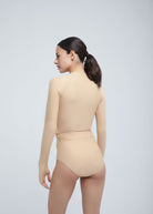 Back view of a woman wearing the IMAN Anti-UV Compressive Top in beige by Fierce Activewear