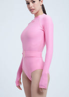 Pink Fierce long-sleeve leotard worn by a model on a light gray background