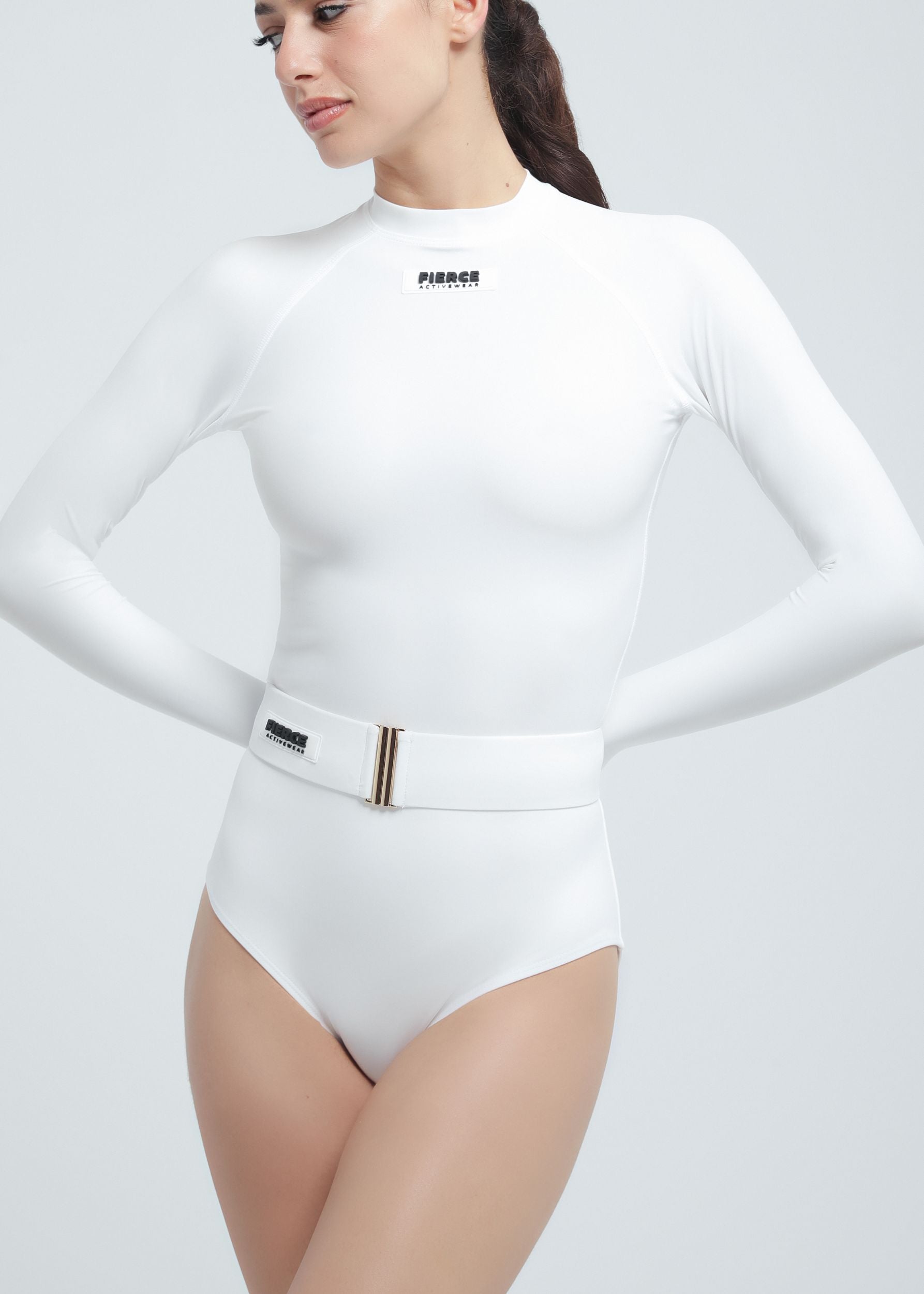 White Fierce bodysuit with a belt worn by a model on a light gray background