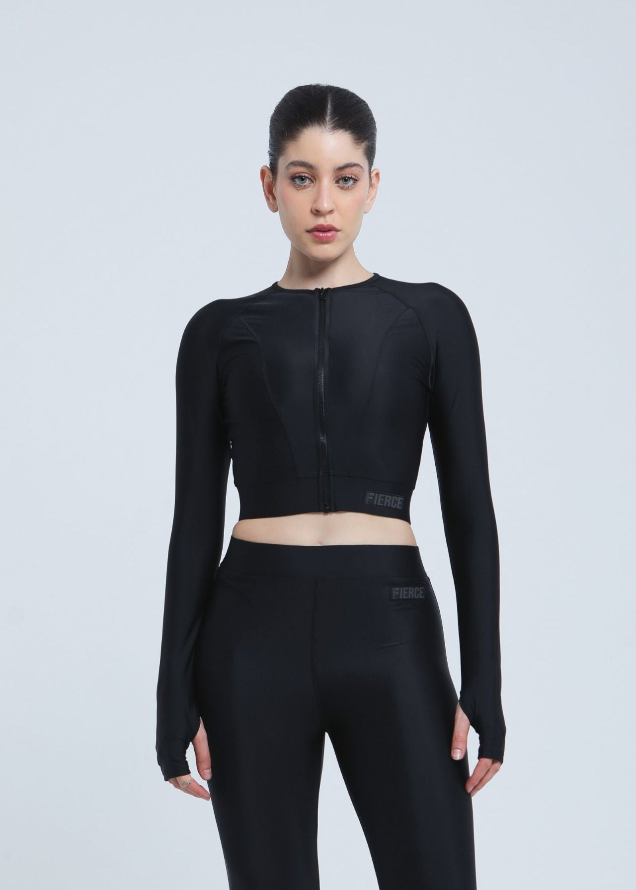 Person wearing a black athletic Fierce outfit on a light gray background