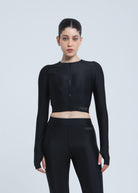 Person wearing a black athletic Fierce outfit on a light gray background