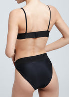 Back view of a woman wearing Fierce Activewear's black Serena bikini set with adjustable straps and a high-waisted bikini bottom
