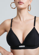 Close-up of a woman wearing the Fierce Activewear black Serena triangle bikini top with logo detail and adjustable straps