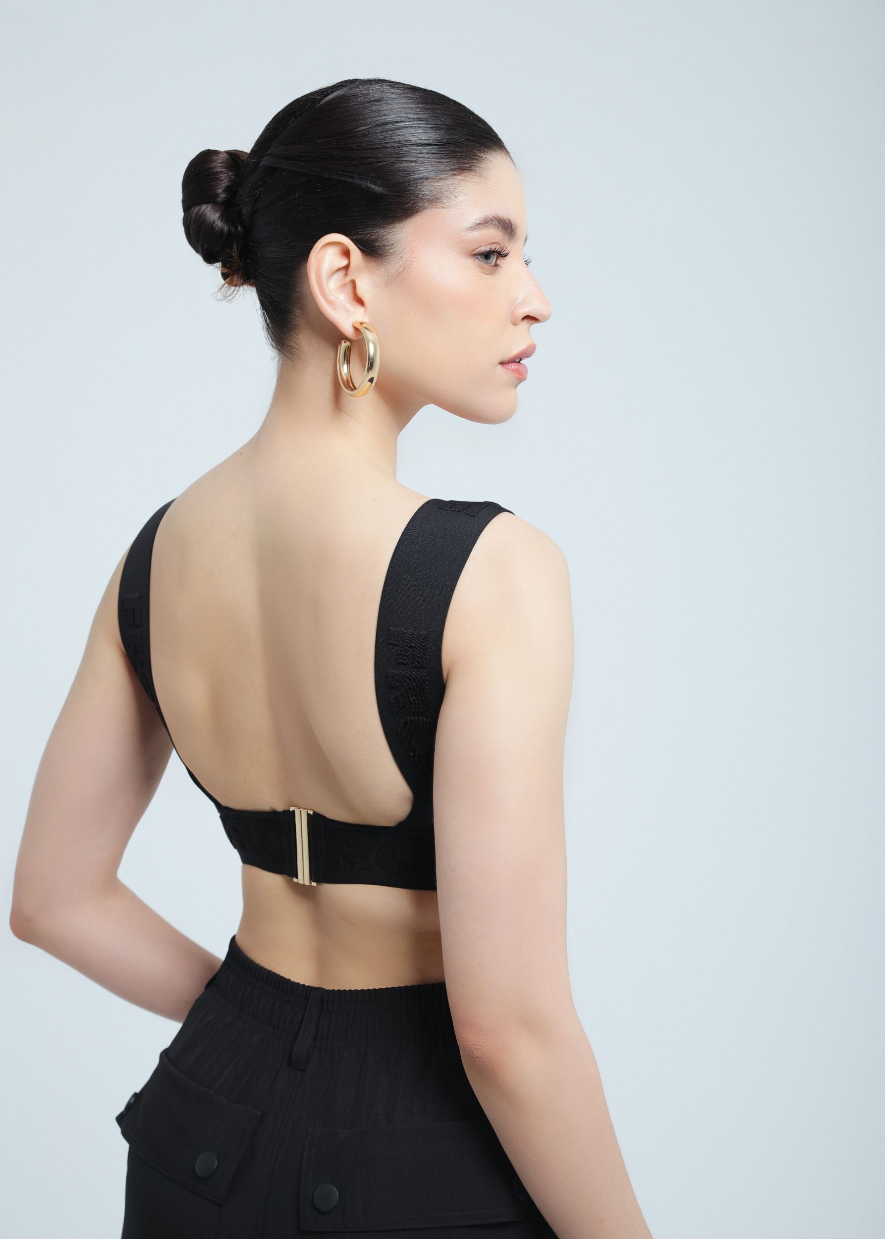 Woman wearing a black Fierce top with a plain background
