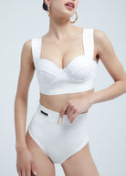 Woman wearing a white Fierce bikini set on a light gray background