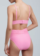 Back view of a woman wearing high-waisted Fierce X-Shape Bottom bikini in pink by Fierce Activewear, featuring a wide logo waistband and flattering contour fit